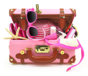 27780287 - ready to travel pink suitcase with summer equipment isolated